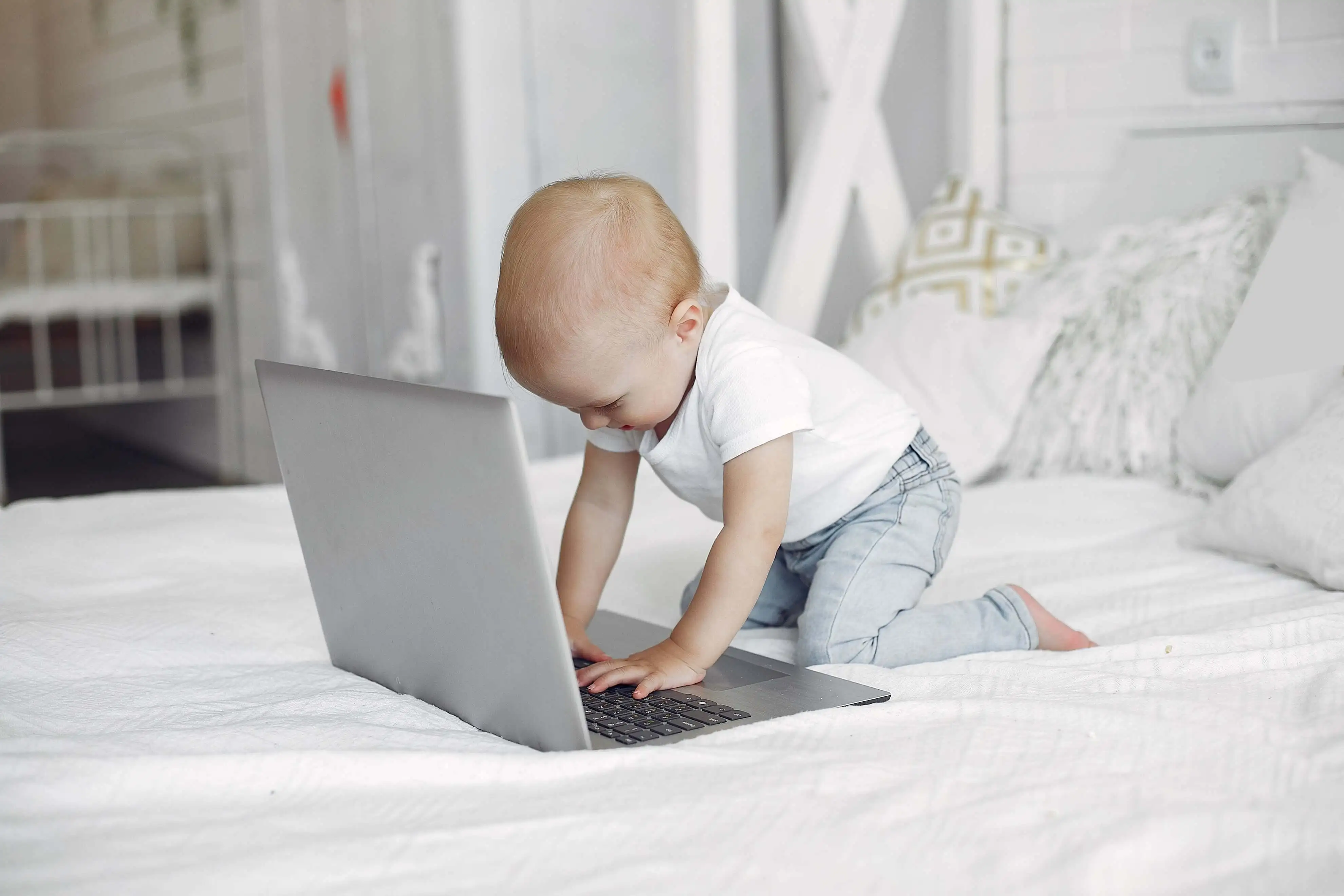 Baby playing on laptop